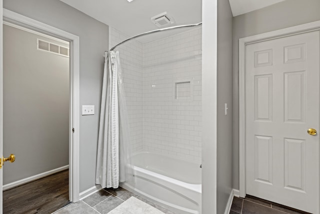 bathroom featuring shower / bath combo and wood-type flooring