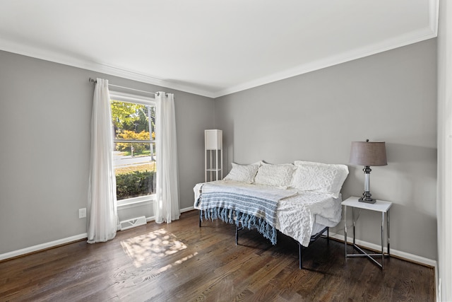 bedroom featuring ornamental molding and dark hardwood / wood-style flooring