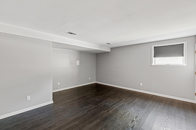 basement with dark hardwood / wood-style floors