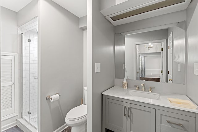 bathroom with toilet, walk in shower, and vanity