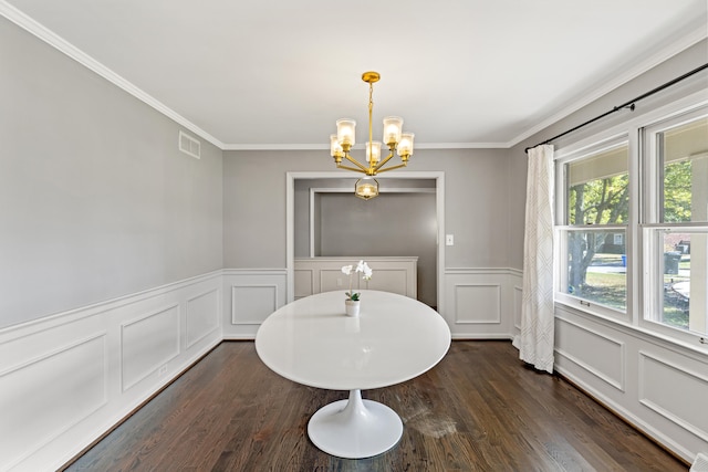 dining space featuring crown molding, a notable chandelier, and dark hardwood / wood-style floors