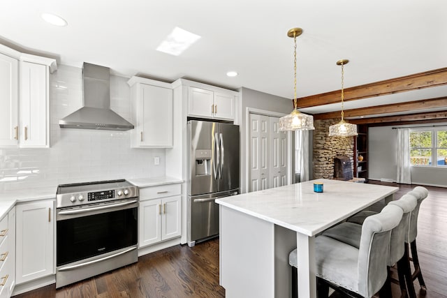 kitchen featuring wall chimney range hood, white cabinetry, stainless steel appliances, and dark wood-type flooring