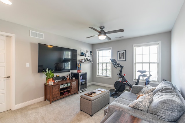 living room with light carpet, plenty of natural light, and ceiling fan