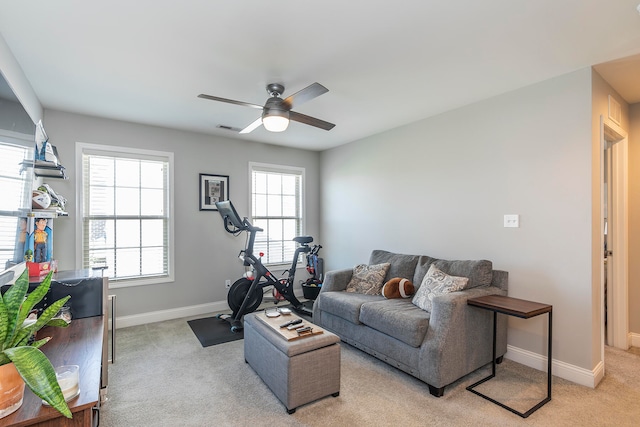 carpeted living room featuring ceiling fan