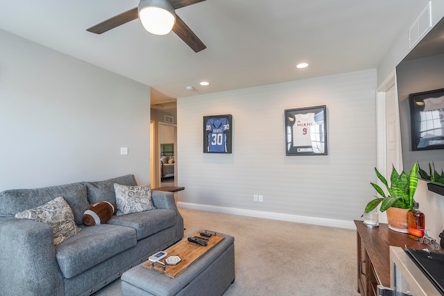 living room featuring light colored carpet and ceiling fan