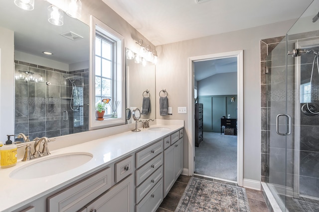 bathroom featuring vanity, tile patterned floors, lofted ceiling, and walk in shower