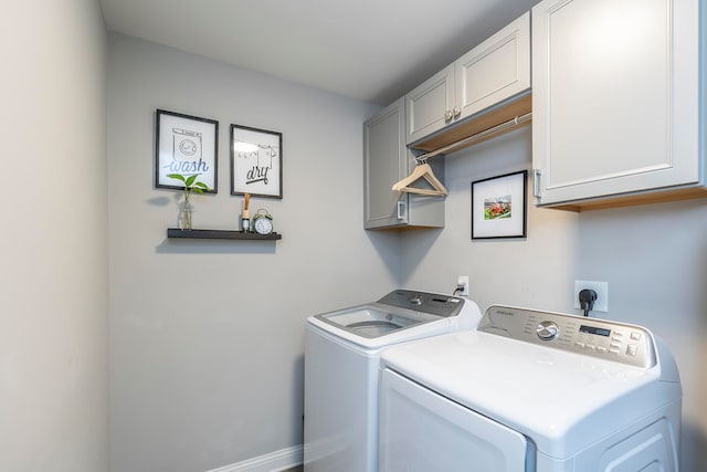 laundry area with cabinets and washing machine and dryer