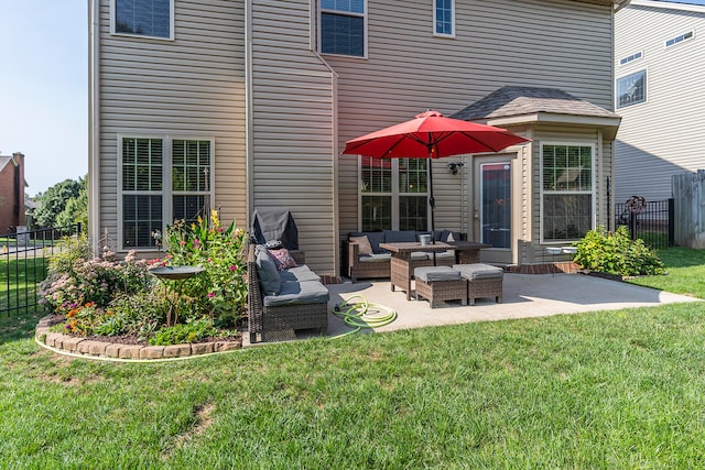 back of house with a patio area, outdoor lounge area, and a lawn