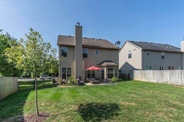 rear view of property featuring a patio area and a yard