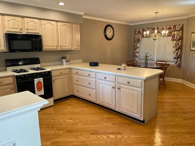 kitchen featuring white gas stove, an inviting chandelier, kitchen peninsula, pendant lighting, and light wood-type flooring