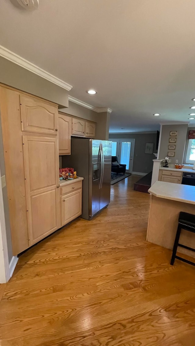 kitchen featuring dishwasher, stainless steel fridge with ice dispenser, light hardwood / wood-style floors, light brown cabinetry, and ornamental molding