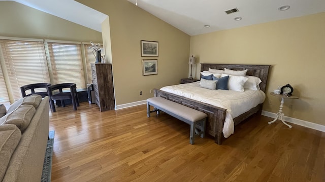 bedroom featuring hardwood / wood-style flooring and high vaulted ceiling