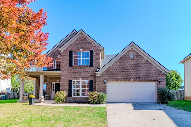 view of front of house with covered porch, a front lawn, and a garage