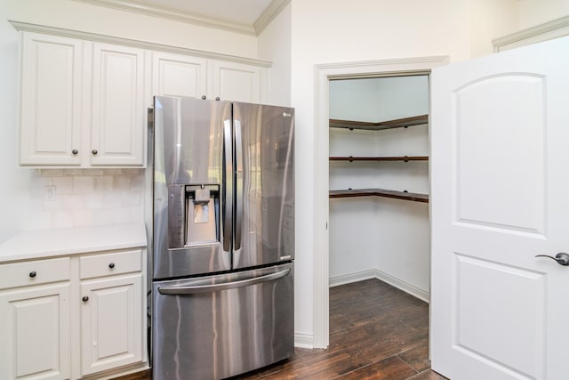 kitchen with white cabinetry, ornamental molding, stainless steel fridge with ice dispenser, and dark hardwood / wood-style flooring