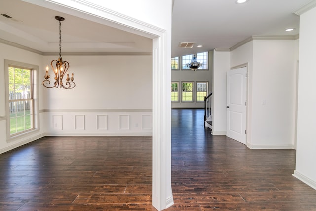 interior space featuring crown molding, a notable chandelier, and dark hardwood / wood-style flooring