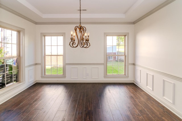 unfurnished dining area featuring ornamental molding, dark wood-type flooring, a notable chandelier, and a raised ceiling