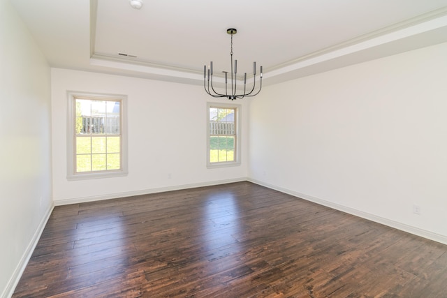 unfurnished room with dark hardwood / wood-style floors, a chandelier, and a tray ceiling