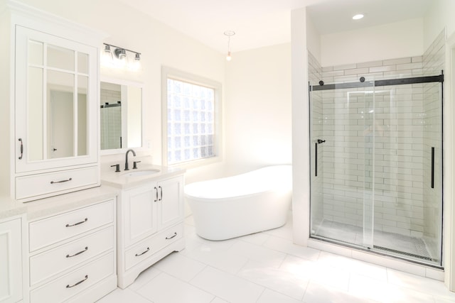 bathroom featuring vanity, independent shower and bath, and tile patterned flooring