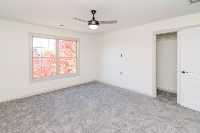 unfurnished bedroom with a closet, ceiling fan, and light colored carpet