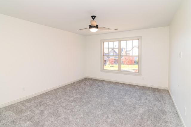 empty room featuring light carpet and ceiling fan