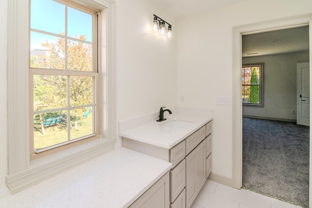 bathroom featuring vanity, tile patterned floors, and plenty of natural light