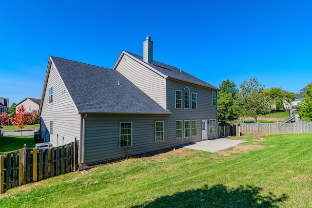 rear view of house featuring a patio and a lawn