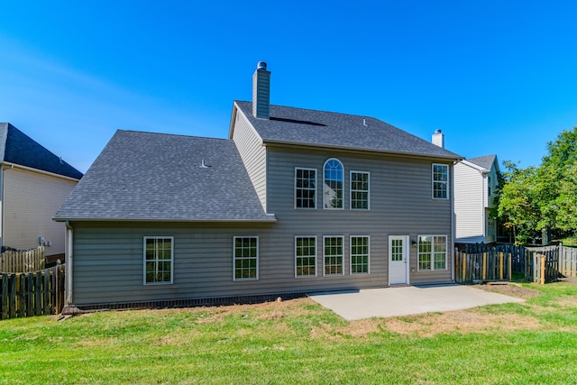 rear view of property with a patio and a lawn