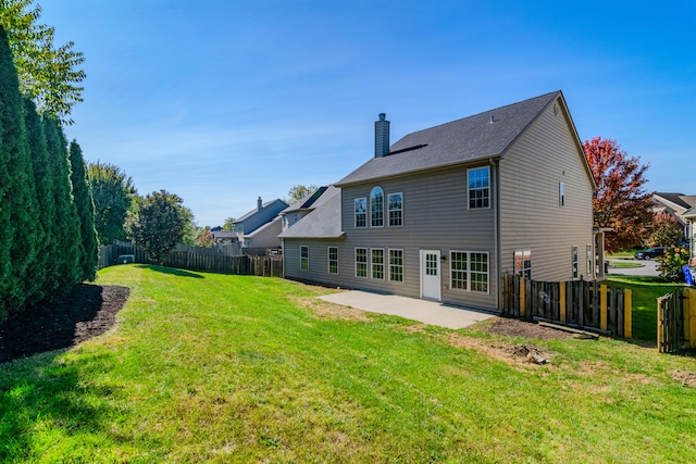 rear view of house with a patio area and a yard