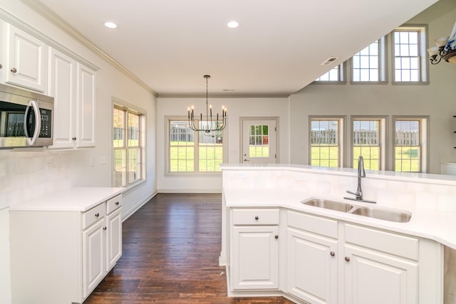 kitchen with dark wood-type flooring, sink, and white cabinets