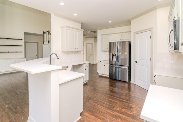 kitchen featuring appliances with stainless steel finishes, white cabinetry, sink, and dark wood-type flooring