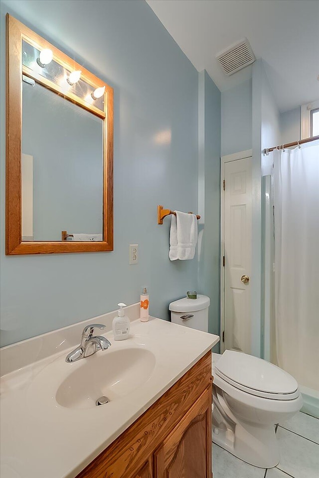 bathroom featuring toilet, a shower with curtain, vanity, and tile patterned flooring