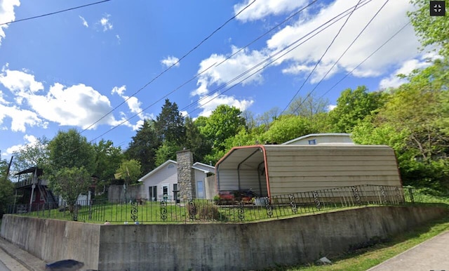 view of home's exterior featuring a yard and a carport