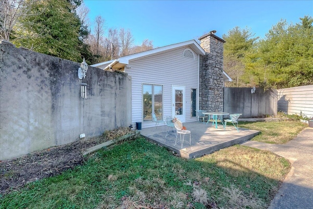 rear view of house with a patio area and a yard