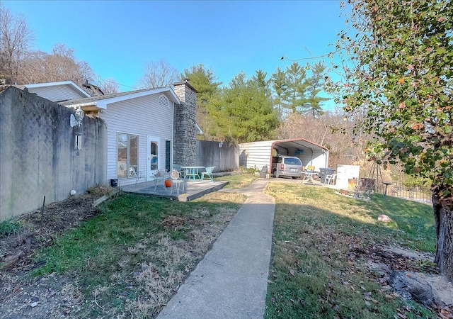 view of yard featuring a deck and a carport