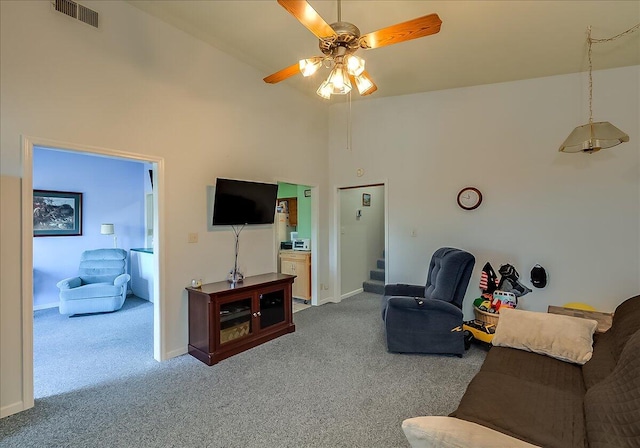 carpeted living room featuring high vaulted ceiling and ceiling fan