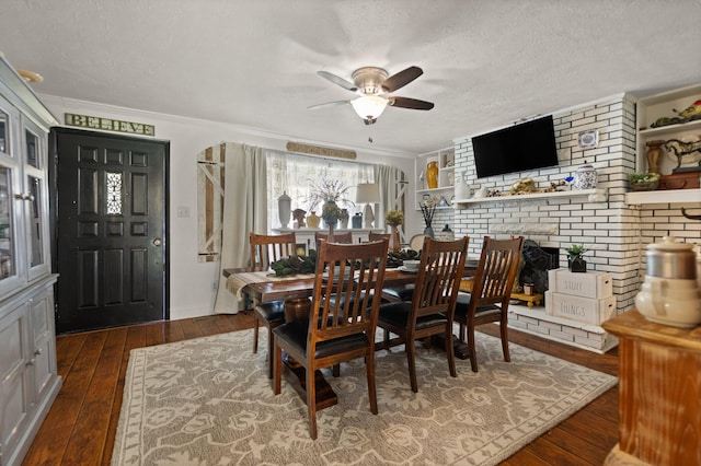 dining room featuring crown molding, dark hardwood / wood-style floors, a textured ceiling, and ceiling fan