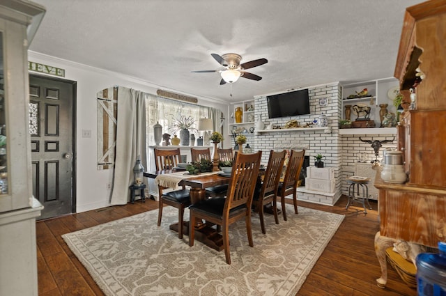 dining room with dark wood-type flooring, ceiling fan, ornamental molding, and a textured ceiling