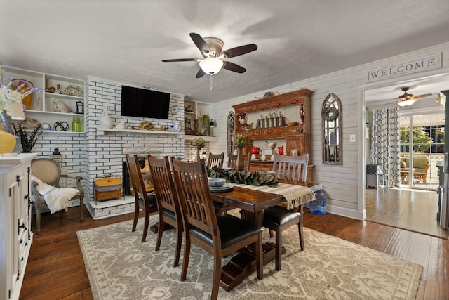 dining room featuring ceiling fan, a textured ceiling, dark hardwood / wood-style flooring, and ornamental molding