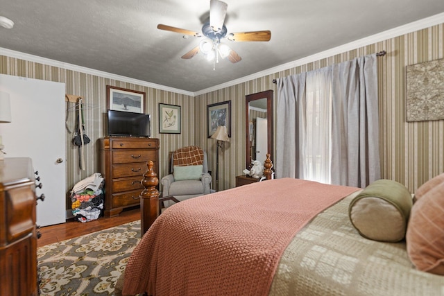 bedroom featuring crown molding, wood-type flooring, and ceiling fan