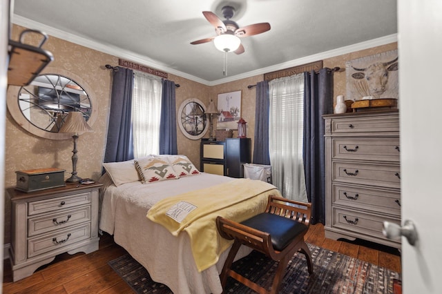 bedroom with ornamental molding, dark hardwood / wood-style floors, and ceiling fan