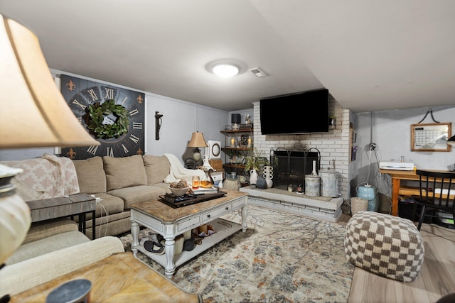 living room with hardwood / wood-style floors and a fireplace