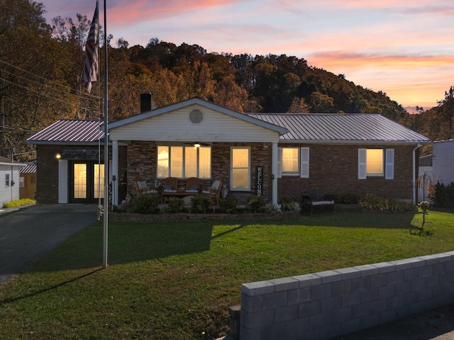 ranch-style home with a lawn