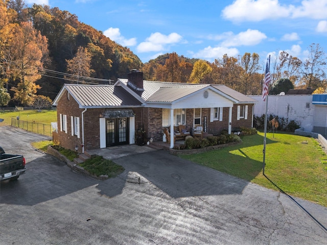 ranch-style home with covered porch and a front lawn