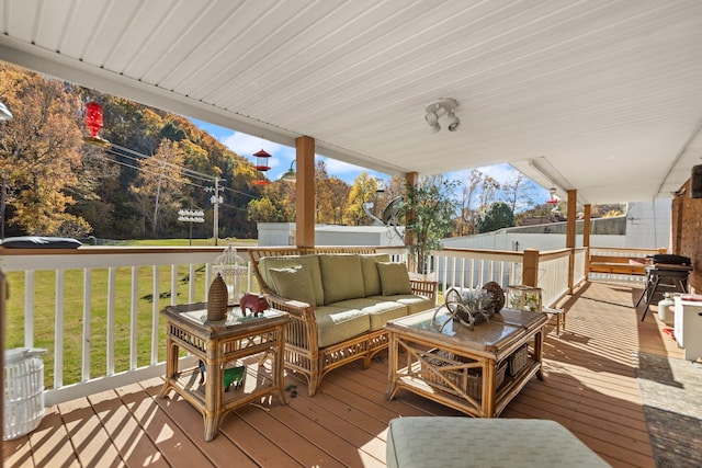 deck featuring a yard and an outdoor living space