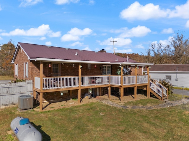 back of property featuring a yard, a deck, and cooling unit