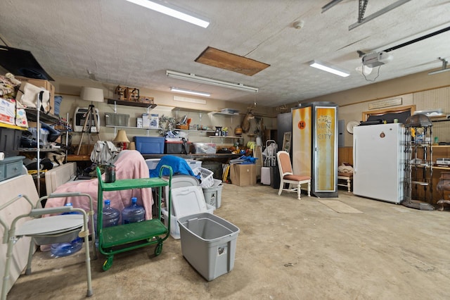 garage featuring a garage door opener and white refrigerator