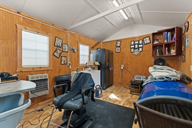 home office with wood walls, lofted ceiling, light wood-type flooring, and heating unit