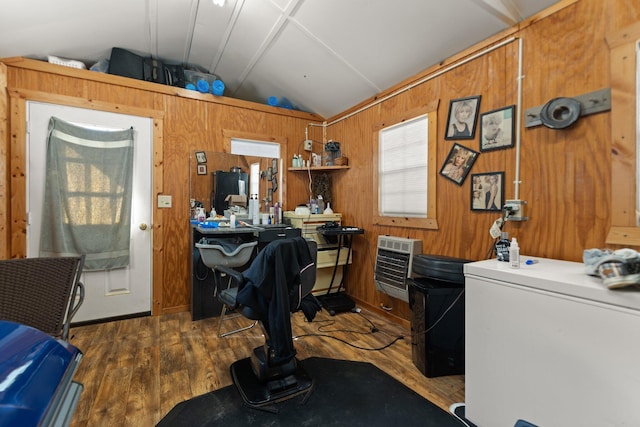 home office featuring wood walls, vaulted ceiling, dark hardwood / wood-style floors, and heating unit