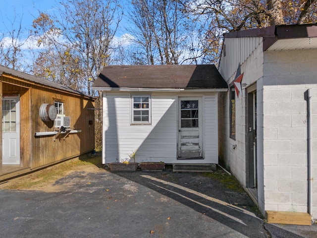 exterior space with cooling unit and a garage