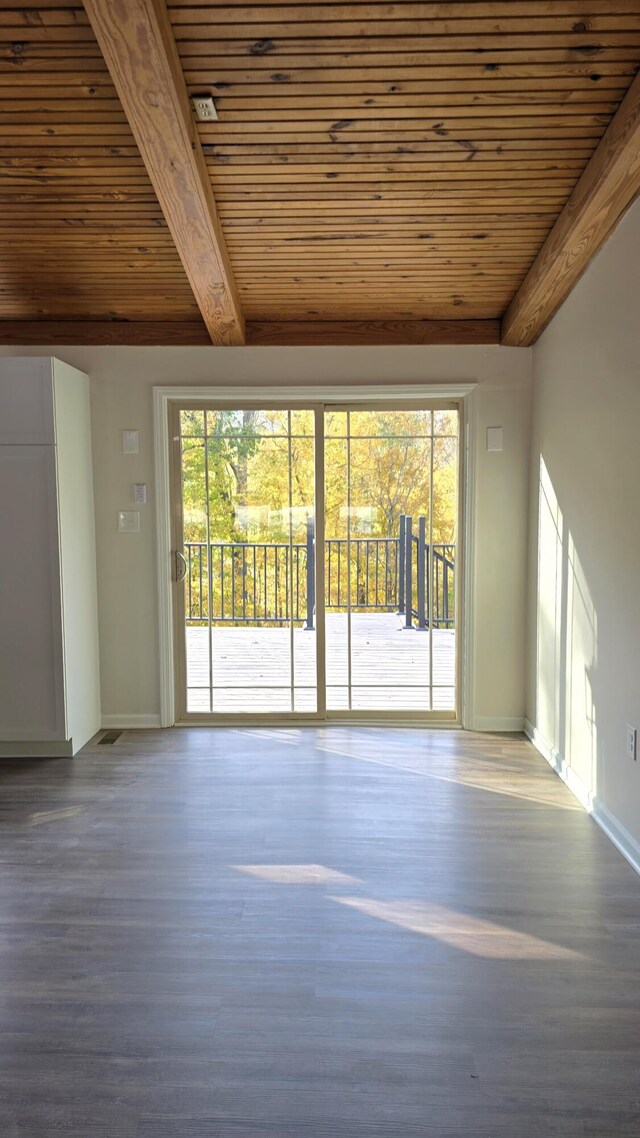 273 Hidden Hills Rd, Lancaster, KY 40444 - unfurnished living room featuring wooden ceiling, a healthy amount of sunlight, wood finished floors, and beam ceiling